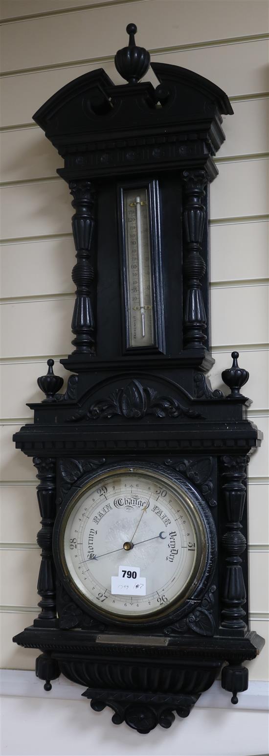 An Edwardian ebonised carved oak aneroid barometer, H.105cm